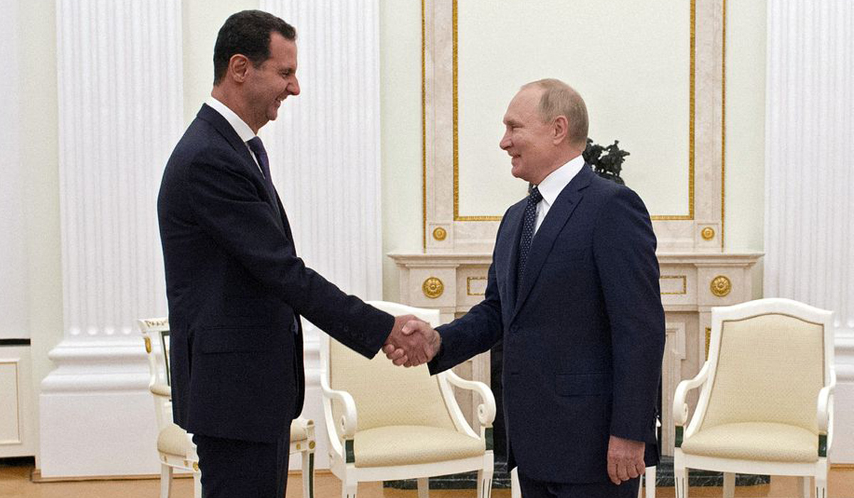 Russian President Vladimir Putin shakes hands with Syrian President Bashar al-Assad